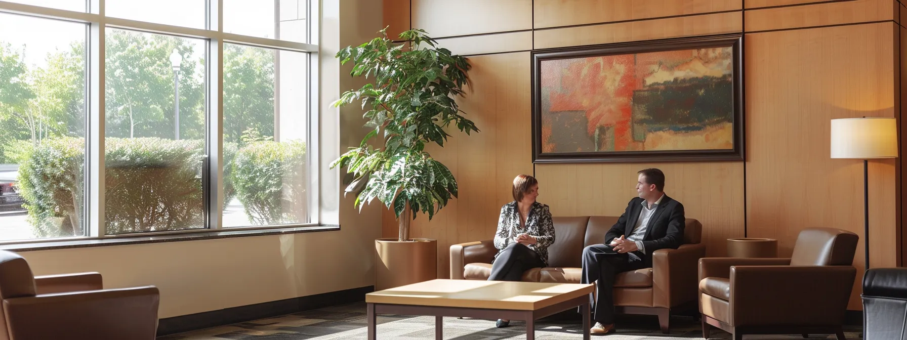 a warm, inviting office space showcases a local divorce attorney engaged in a thoughtful conversation with a client, highlighting the close-knit community atmosphere and the importance of transparency and trust in legal relationships.